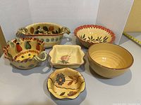 Overview of all five ceramic serving bowls showing shapes and hand-painted designs