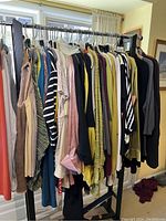 Photo of various colorful shirts on hangers showing assortment of sleeve styles, patterns, and colors.