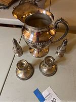 Group shot of pitcher, two candlestick holders and salt and pepper shakers