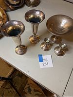 Overview of two vases, two candleholders, and one dish displayed on table