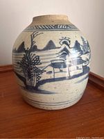 Side angle showing the overall rounded shape and landscape hand-painted design on the vase surface.