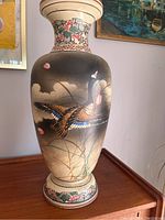 Full view of large Japanese ceramic vase showcasing bird and floral painting and crackled glaze.