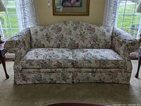 Front view of floral fabric Broyhill sofa with two seat cushions and arm covers.