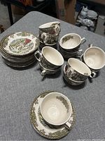Set of 6 reunited teacups positioned on a grey fabric surface, showing the interior and the pattern on the exterior.