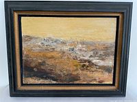 Full view of framed abstract landscape oil painting with a yellow sky and earthy foreground tones.