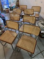Six Cesca-style chairs grouped: chrome frames with cane seats and backs