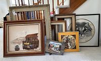 Image showing 7 frames of various sizes with paintings and prints including dock scene and feline portrait