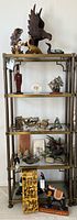Four-tier shelf with assorted bird sculptures, figurines, menorahs, lamp shade, and decorative items