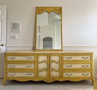 Photo showing the front view of the vintage dresser with mirror placed on top, highlighting French provincial style and dresser drawer layout.