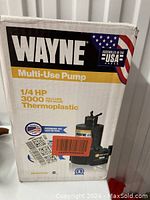 Front view of the Wayne Multi-Use Pump box showing brand, model details, 1/4 HP power and 3000 gallons per hour capacity in thermoplastic.
