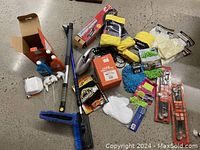 Lot contents including brushes, cleaning liquids, microfiber cloths, and pressure washer box