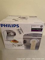 Front view of the Philips pasta maker box showing the product image, brand Philips, Avance Collection designation, and pasta extruding from the machine.