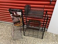 Photo showing metal mesh desk organizer on top of a two-tier black metal Metro shelving unit, with smaller wire item beside it and boxed side table.