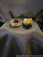 Front view of both rings displayed on black cloth