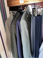 Coats and blazers hanging with a view showing different colors and styles