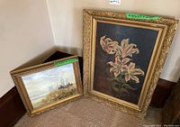 Both paintings leaned against a wall showing size contrast and frames.