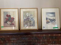 Two floral prints in wood frames with glass fronts, and one framed watercolor painting by Gaby Verge