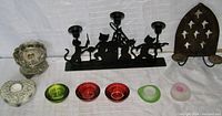 Photo showing all 9 tea light candle holders including the metal cat musical band holder, colorful glass holders, heart-shaped rock holder, and others.