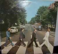 Front cover of the Beatles Abbey Road album showing the band crossing the street.