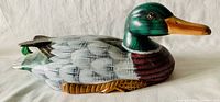 Photo showing the right side of the detailed hand carved and painted wooden duck decoy with green head and brown chest.