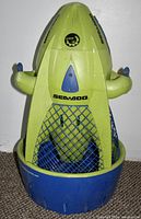 Front view of green and blue Sea-Doo Seascooter Dolphin water propulsion device with safety grille and handles.