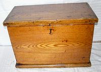 Front view of the vintage solid oak box showing latch and wood grain.