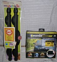 Photo showing Munchkin vinyl sun block shades packaged, with a white hot temperature indicator feature and Bell + Howell Weather Force 360 windshield guard packaging.
