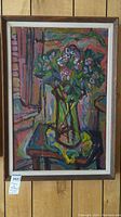 Full frontal view of the framed canvas painting depicting a floral arrangement in a vase.