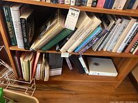 Top view of two shelves of assorted books with titles visible including Catherine the Great, The Discoverers, Maya, and others.