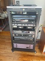 Full view of rack on wheels holding five rack-mount components