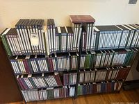 Two black metal shelving units loaded with rows of multi-colored DVD cases