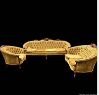 Front view of the antique sofa and two chairs showing fabric upholstery and carved wood details