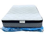 Front-facing photo of the Kingsdown Scarlet plush queen mattress set on an under bed frame with a plastic cover.