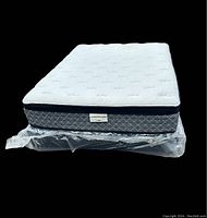 Front view of mattress and foundation, showing quilted white top, grey diamond pattern side, and plastic wrapped foundation underneath