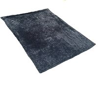 Black plush rectangular area rug photographed from different angles showing texture and size.