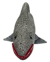 Front view of gray plush shark dog toy with scale pattern and red mouth.