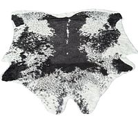 Full view of the black and white faux animal hide shaped rug on white background, showing pattern and shape.