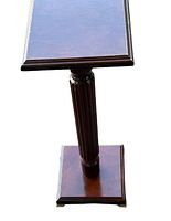 Front view of vintage Bombay Co. mahogany finish pedestal, showing rectangular top, fluted column, and square base.