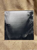 Full front view of the framed abstract landscape painting in monochromatic black and gray tones.