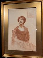 Framed Conté crayon drawing of seated woman, showing overall artwork and frame with glass.