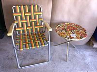 Photo of vintage folding patio chair and occasional table placed on concrete floor, showing woven webbing pattern on the chair and floral top on table
