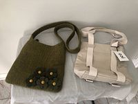 Green felt handbag next to beige canvas purse showing details and overall condition