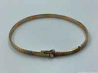 Full bracelet laid flat on white background showing shape and clasp