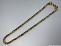 Full view of necklace laid flat to show overall length and design