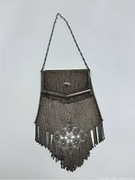 Full view of the antique evening purse showing overall shape, chain handle, and flap.