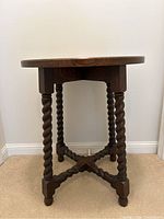 Overall view of round oak side table showing barley twist legs
