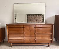 Front view of six-drawer walnut dresser with mirror attached