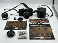 Full overview of camera body, lenses, case, manuals, brochure, caps, filter and adapter