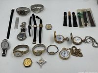 Overview of lot showing wristwatches, pocket watches, pendant watch and straps