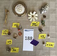 Overview of all jewelry and mirror on fabric background with lot card